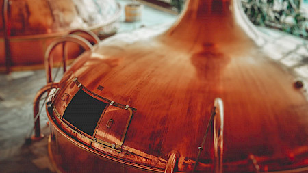 A copper brew tank in a brewery